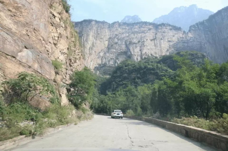 图中山区道路跟车行驶时视线受阻，要适当减速，加大跟车距离。